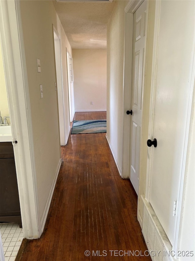 339 W 62nd St N, Tulsa, OK 74126 - corridor with baseboards, wood-type flooring, and a textured ceiling