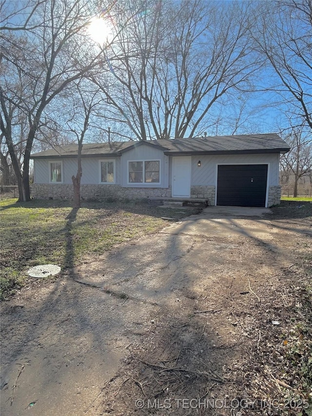 339 W 62nd St N, Tulsa, OK 74126 - ranch-style home with stone siding, driveway, and a garage