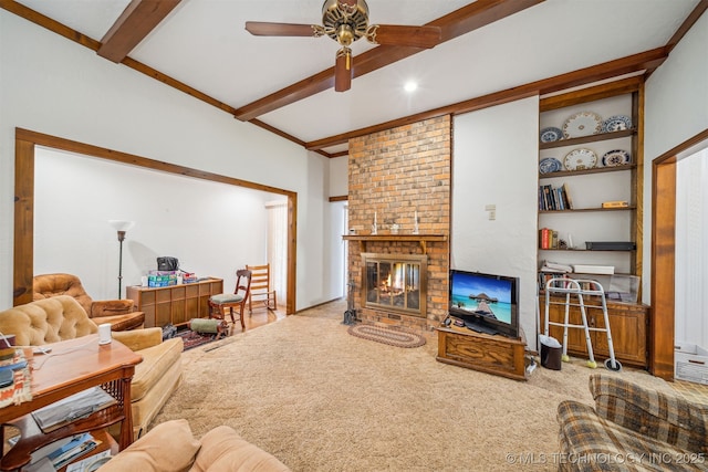 living room with a brick fireplace, beamed ceiling, carpet floors, and ceiling fan