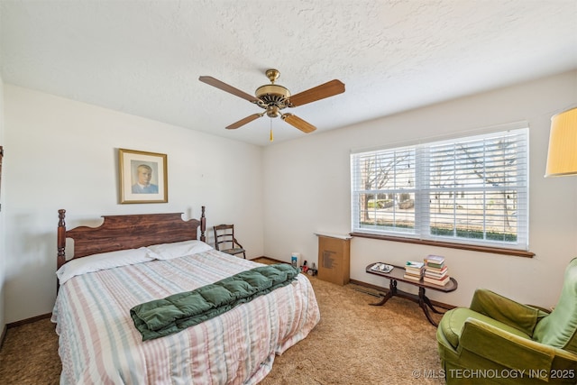 carpeted bedroom with a ceiling fan, baseboards, and a textured ceiling