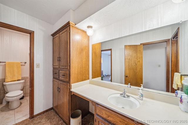 bathroom with vanity, toilet, and tile patterned flooring