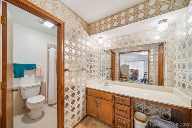 bathroom featuring wallpapered walls, toilet, and vanity