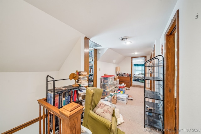 additional living space with visible vents, lofted ceiling, carpet, and baseboards