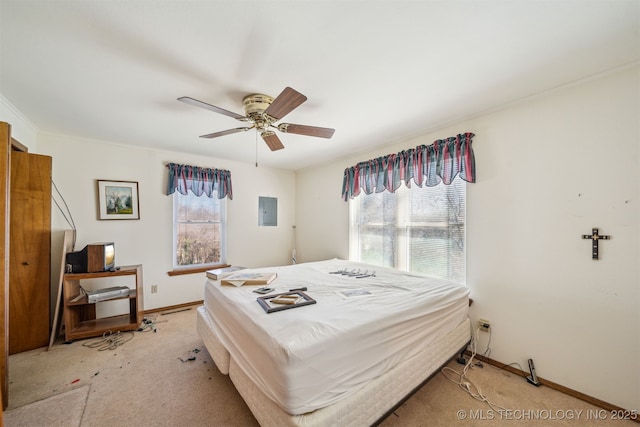 bedroom featuring electric panel, light carpet, a ceiling fan, and baseboards