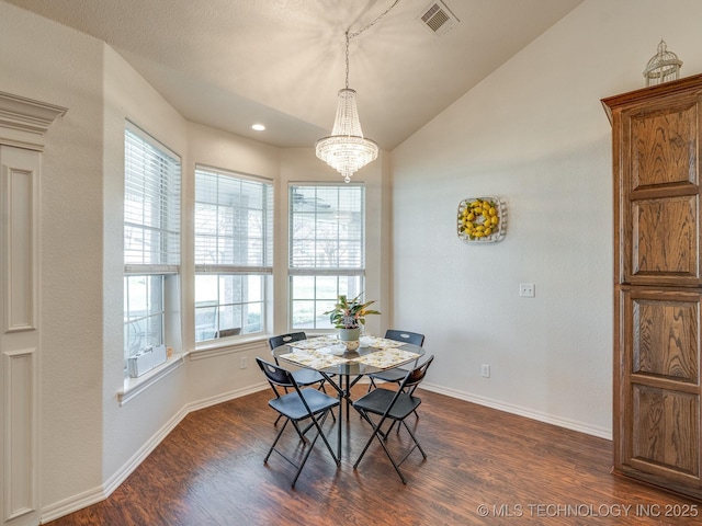 dining room featuring baseboards, visible vents, an inviting chandelier, lofted ceiling, and dark wood-style flooring