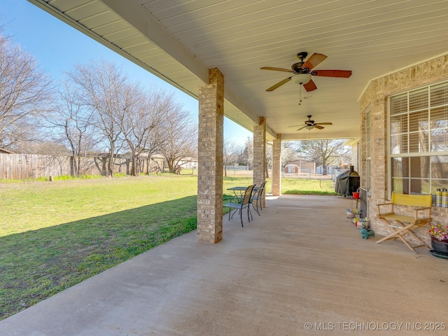 view of patio / terrace featuring a ceiling fan and fence