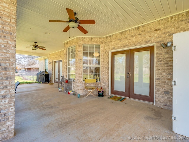 view of patio / terrace featuring a ceiling fan, french doors, fence, and grilling area