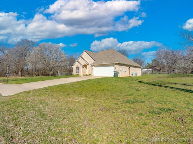 view of side of home with fence, driveway, a garage, a lawn, and brick siding