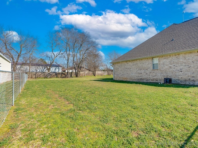 view of yard with central air condition unit and a fenced backyard