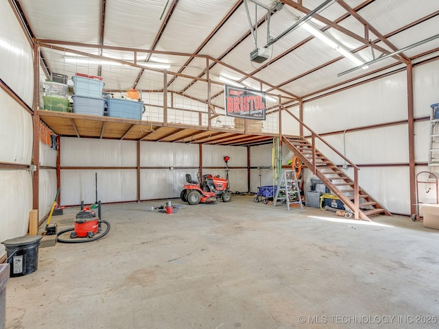 garage with a garage door opener and metal wall