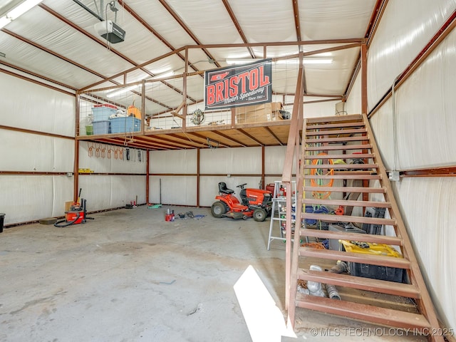 garage with a garage door opener and metal wall