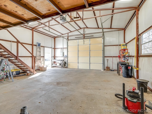 garage featuring a garage door opener and metal wall