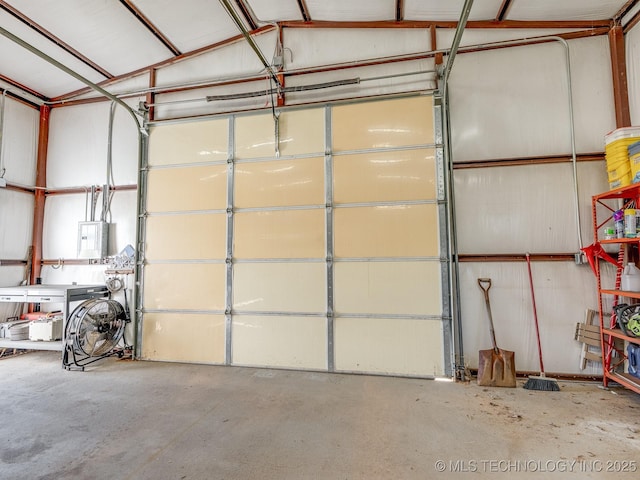 garage with electric panel and metal wall