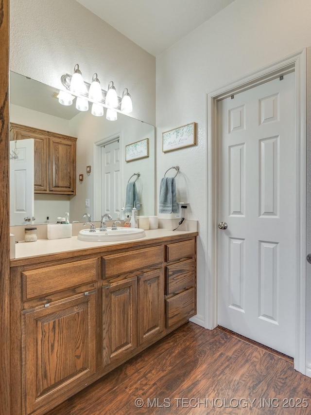 bathroom with vanity and wood finished floors