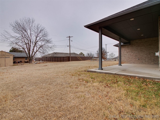 view of yard featuring an outbuilding and a patio area