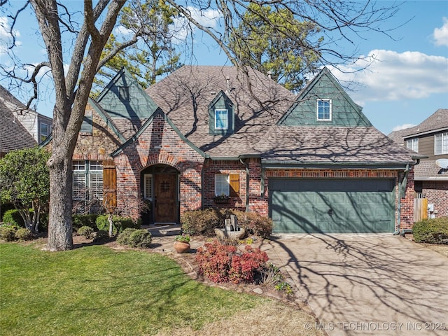 view of front of home with driveway, a front yard, a shingled roof, a garage, and brick siding