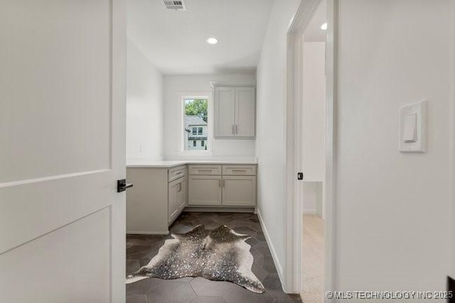 bathroom with vanity, baseboards, and visible vents