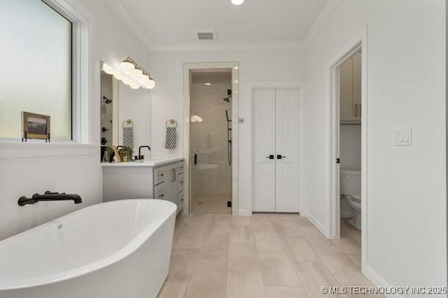 full bathroom featuring a shower stall, a freestanding tub, crown molding, and visible vents