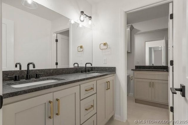 bathroom featuring double vanity and a sink