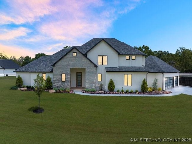 view of front of property with a shingled roof, concrete driveway, a garage, stone siding, and a lawn