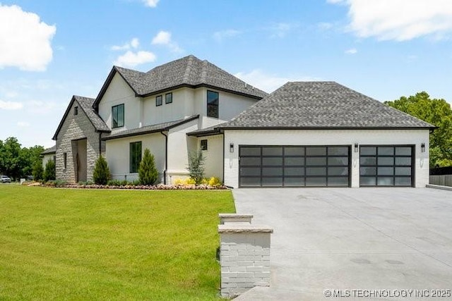 view of front of home featuring concrete driveway, a front yard, roof with shingles, stucco siding, and a garage