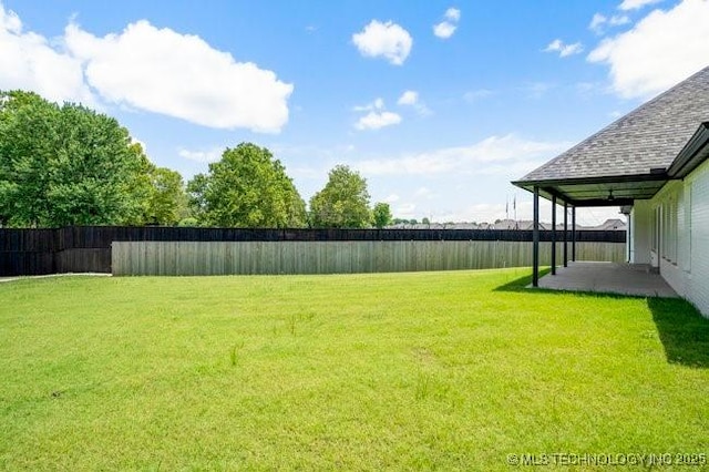 view of yard with a patio and fence