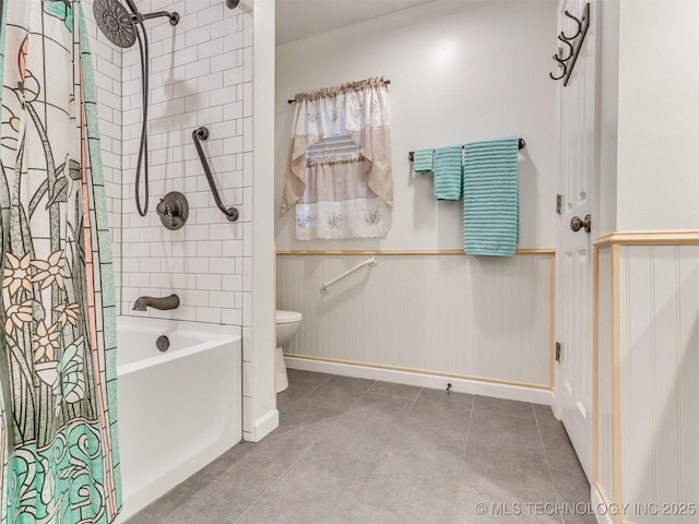 bathroom featuring tile patterned floors, a wainscoted wall, toilet, and ornamental molding