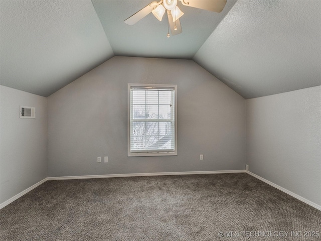 bonus room with lofted ceiling, carpet, visible vents, and a textured ceiling