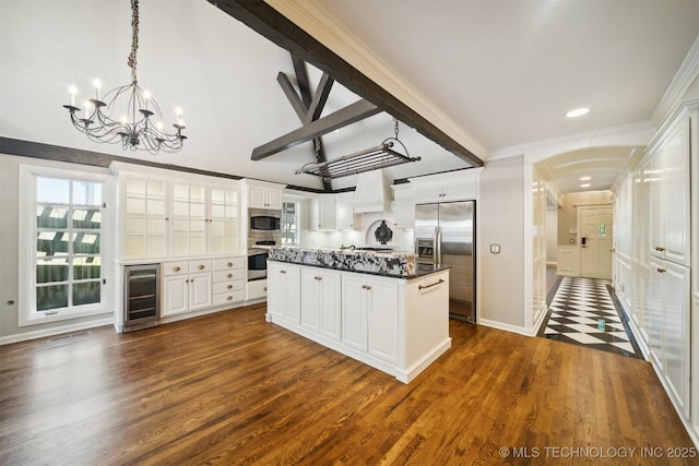 kitchen with custom range hood, dark wood finished floors, a center island, wine cooler, and appliances with stainless steel finishes