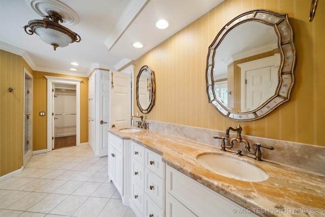 full bathroom with tile patterned floors, crown molding, double vanity, and a sink