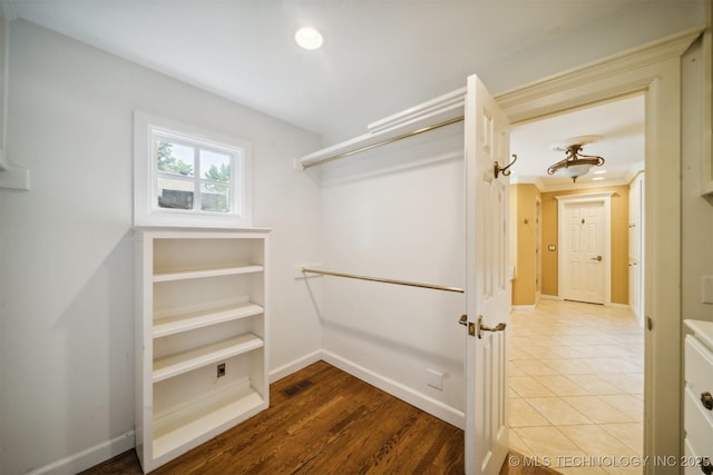 walk in closet featuring visible vents and wood finished floors