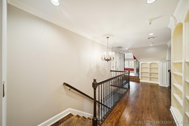 stairs featuring visible vents, built in shelves, wood finished floors, baseboards, and a chandelier