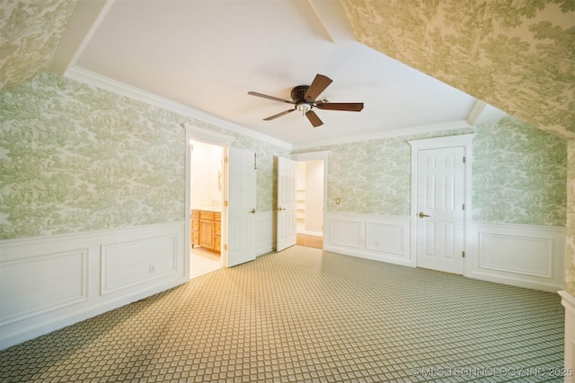 additional living space featuring wallpapered walls, carpet flooring, a ceiling fan, and wainscoting