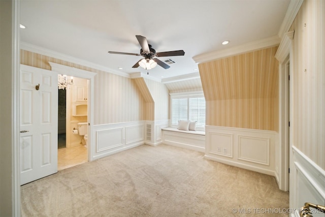 additional living space with wallpapered walls, a wainscoted wall, carpet flooring, and visible vents