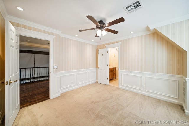 219 E 28th St, Tulsa, OK 74114 - unfurnished bedroom with crown molding, wallpapered walls, a decorative wall, a wainscoted wall, and carpet flooring