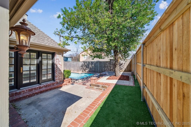 view of yard with a fenced backyard and a patio