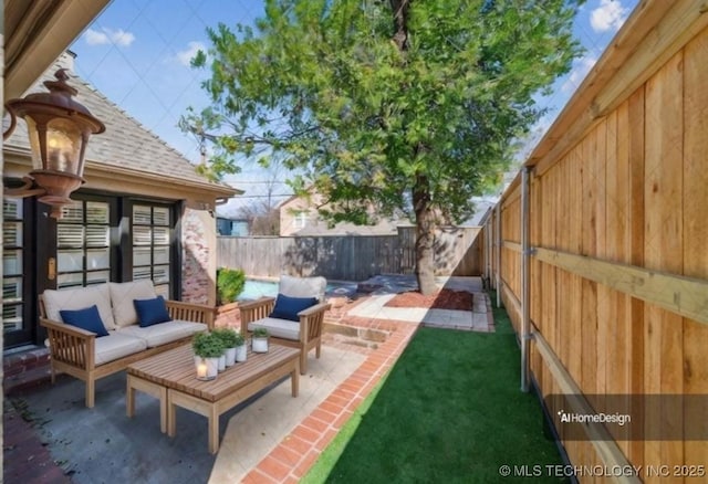 219 E 28th St, Tulsa, OK 74114 - fenced backyard with an outdoor living space and a patio area