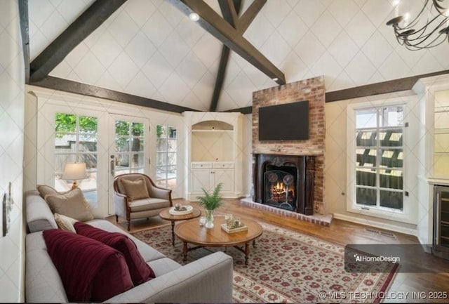 219 E 28th St, Tulsa, OK 74114 - living area featuring a brick fireplace, wood finished floors, and high vaulted ceiling