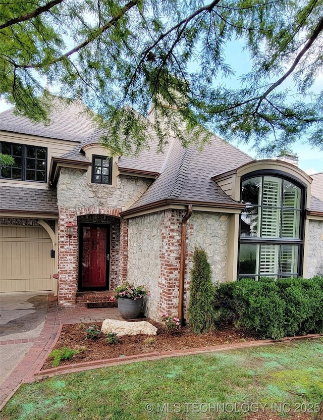 219 E 28th St, Tulsa, OK 74114 - french country style house with stone siding, a shingled roof, and stucco siding