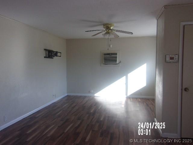 empty room with baseboards, an AC wall unit, wood finished floors, and a ceiling fan