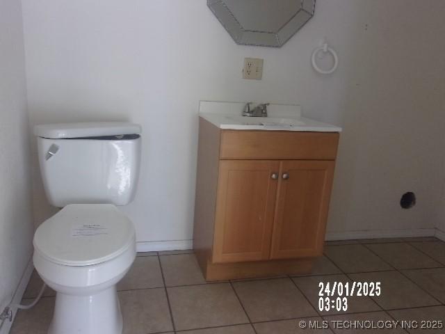 bathroom featuring tile patterned floors, toilet, vanity, and baseboards