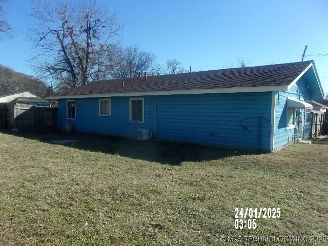 rear view of house with a yard