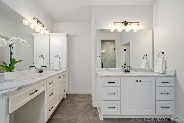 bathroom with an enclosed shower, two vanities, baseboards, and a sink