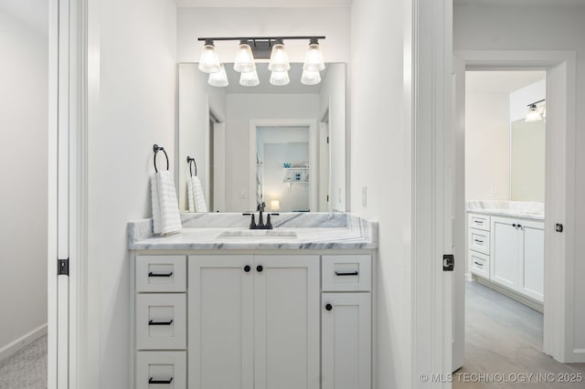 bathroom featuring two vanities and a sink