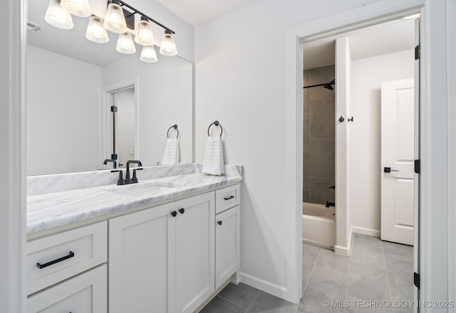 bathroom with tile patterned floors, visible vents, baseboards, bathing tub / shower combination, and vanity