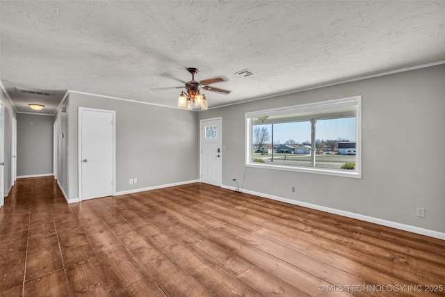 unfurnished living room with ceiling fan, wood finished floors, baseboards, and a textured ceiling