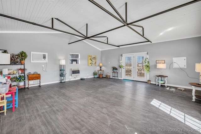 garage with an AC wall unit, heating unit, french doors, and baseboards