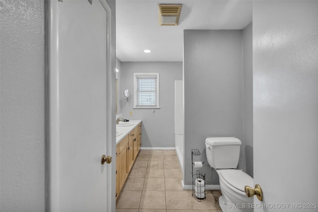 bathroom with tile patterned floors, visible vents, toilet, baseboards, and vanity