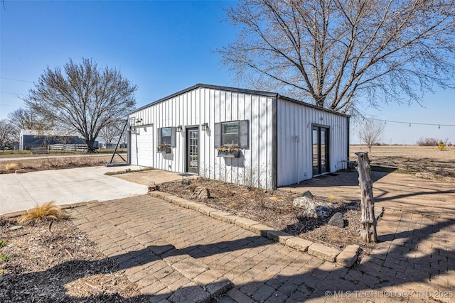 view of outbuilding featuring an outbuilding, decorative driveway, and a garage