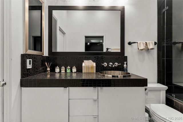 2440 E 47th Pl, Tulsa, OK 74105 - bathroom featuring backsplash, vanity, and toilet
